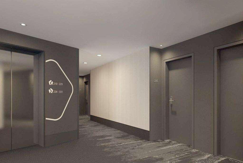 ไฮเปเรียน โฮเต็ล มึนเชิน Hotel มิวนิก ภายใน รูปภาพ The photo shows a modern hotel corridor. On the left side, there is an elevator with a sleek design, and next to it are wall graphics or signage. The corridor has a neutral color scheme, primarily gray with a light beige wall. Doors to guest rooms ar